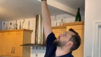 Ben reaching for fire alarm