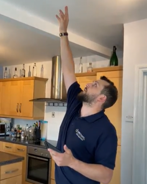 Ben reaching for fire alarm